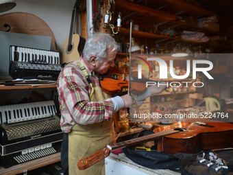 Former theatre actor and long time artist and luthier, Jozef Gmyrek (age 71), tunes a violin in his workshop.
His work is not a job but a pa...