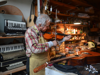 Former theatre actor and long time artist and luthier, Jozef Gmyrek (age 71), tunes a violin in his workshop.
His work is not a job but a pa...