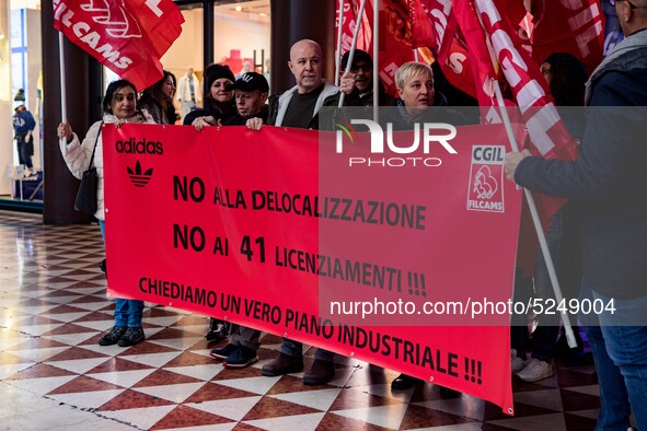 Employees of the well-known clothing brand Adidas protest in front of the Adidas store in Milan against the 41 dismissals due to the relocat...