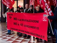 Employees of the well-known clothing brand Adidas protest in front of the Adidas store in Milan against the 41 dismissals due to the relocat...