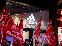 Employees of the well-known clothing brand Adidas protest in front of the Adidas store in Milan against the 41 dismissals due to the relocat...