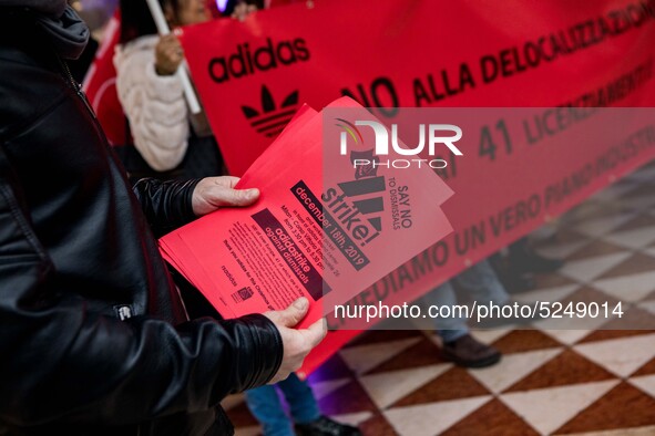 Employees of the well-known clothing brand Adidas protest in front of the Adidas store in Milan against the 41 dismissals due to the relocat...