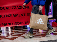 Employees of the well-known clothing brand Adidas protest in front of the Adidas store in Milan against the 41 dismissals due to the relocat...