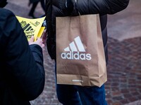 Employees of the well-known clothing brand Adidas protest in front of the Adidas store in Milan against the 41 dismissals due to the relocat...