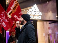 Employees of the well-known clothing brand Adidas protest in front of the Adidas store in Milan against the 41 dismissals due to the relocat...