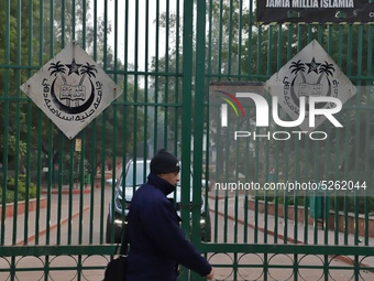 A man walks past the gate of Jamia Millia Islamia University, in New Delhi, India on 23 December 2019 (