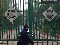 A man walks past the gate of Jamia Millia Islamia University, in New Delhi, India on 23 December 2019 (