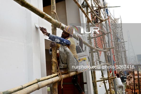 Bangladeshi day labor works at the construction site of Dhaka international Trade Fair in Dhaka, Bangladesh, on December 26, 2019. 