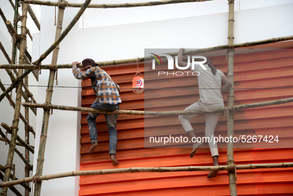 Bangladeshi day labor works at the construction site of Dhaka international Trade Fair in Dhaka, Bangladesh, on December 26, 2019. 