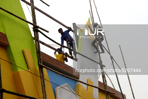 Bangladeshi day labor works at the construction site of Dhaka international Trade Fair in Dhaka, Bangladesh, on December 26, 2019. 