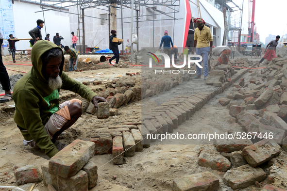 Bangladeshi day labor works at the construction site of Dhaka international Trade Fair in Dhaka, Bangladesh, on December 26, 2019. 