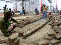 Bangladeshi day labor works at the construction site of Dhaka international Trade Fair in Dhaka, Bangladesh, on December 26, 2019. (