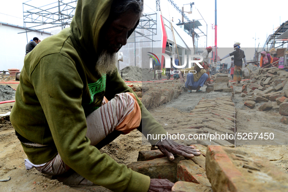 Bangladeshi day labor works at the construction site of Dhaka international Trade Fair in Dhaka, Bangladesh, on December 26, 2019. 