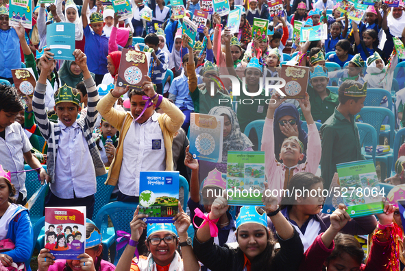 Student celebrate with new textbooks in hand at the Dhaka University sports ground the Dhaka University sports ground as the government kick...