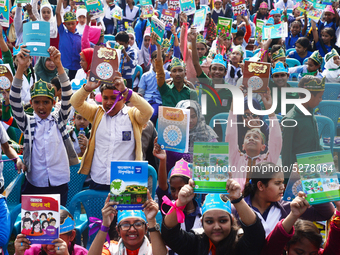 Student celebrate with new textbooks in hand at the Dhaka University sports ground the Dhaka University sports ground as the government kick...