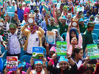 Student celebrate with new textbooks in hand at the Dhaka University sports ground the Dhaka University sports ground as the government kick...