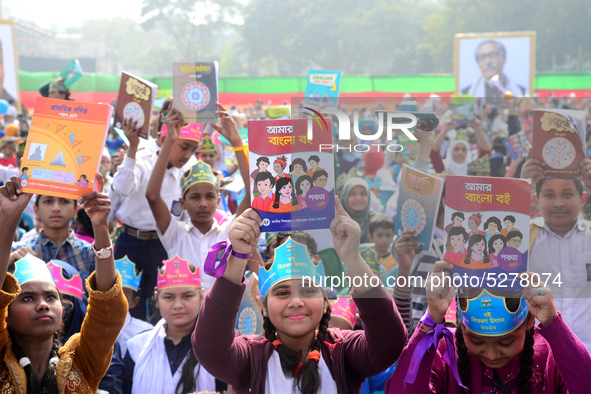 Student celebrate with new textbooks in hand at the Dhaka University sports ground the Dhaka University sports ground as the government kick...