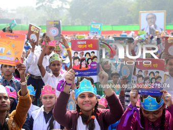 Student celebrate with new textbooks in hand at the Dhaka University sports ground the Dhaka University sports ground as the government kick...