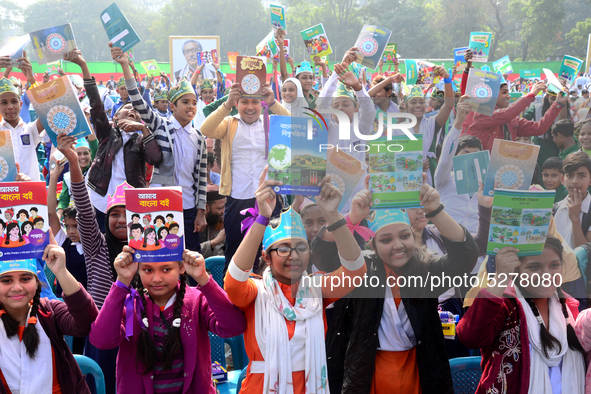 Student celebrate with new textbooks in hand at the Dhaka University sports ground the Dhaka University sports ground as the government kick...