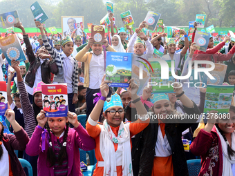 Student celebrate with new textbooks in hand at the Dhaka University sports ground the Dhaka University sports ground as the government kick...