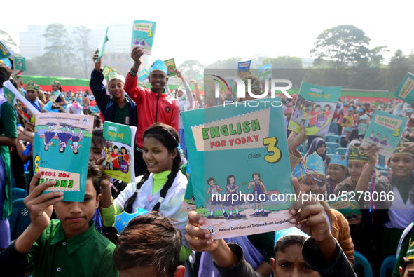 Student celebrate with new textbooks in hand at the Dhaka University sports ground the Dhaka University sports ground as the government kick...