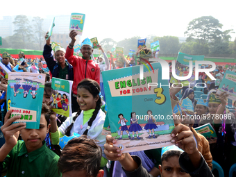 Student celebrate with new textbooks in hand at the Dhaka University sports ground the Dhaka University sports ground as the government kick...