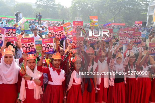 Student celebrate with new textbooks in hand at the Dhaka University sports ground the Dhaka University sports ground as the government kick...