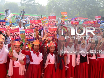 Student celebrate with new textbooks in hand at the Dhaka University sports ground the Dhaka University sports ground as the government kick...