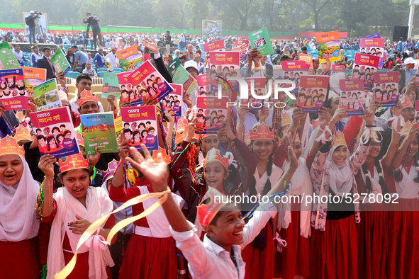 Student celebrate with new textbooks in hand at the Dhaka University sports ground the Dhaka University sports ground as the government kick...