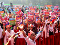 Student celebrate with new textbooks in hand at the Dhaka University sports ground the Dhaka University sports ground as the government kick...