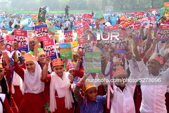 Student celebrate with new textbooks in hand at the Dhaka University sports ground the Dhaka University sports ground as the government kick...