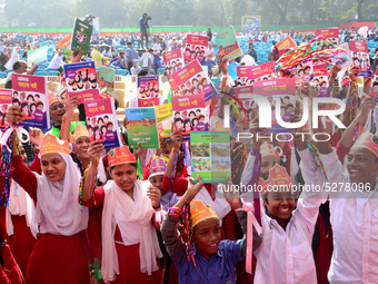 Student celebrate with new textbooks in hand at the Dhaka University sports ground the Dhaka University sports ground as the government kick...