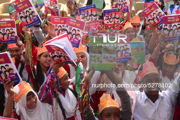 Student celebrate with new textbooks in hand at the Dhaka University sports ground the Dhaka University sports ground as the government kick...