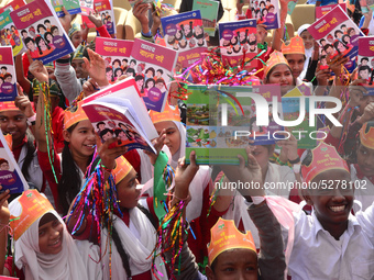 Student celebrate with new textbooks in hand at the Dhaka University sports ground the Dhaka University sports ground as the government kick...