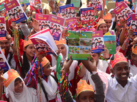 Student celebrate with new textbooks in hand at the Dhaka University sports ground the Dhaka University sports ground as the government kick...