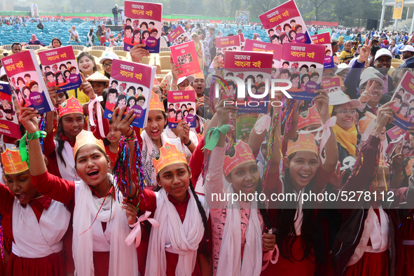 Student celebrate with new textbooks in hand at the Dhaka University sports ground the Dhaka University sports ground as the government kick...