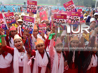 Student celebrate with new textbooks in hand at the Dhaka University sports ground the Dhaka University sports ground as the government kick...