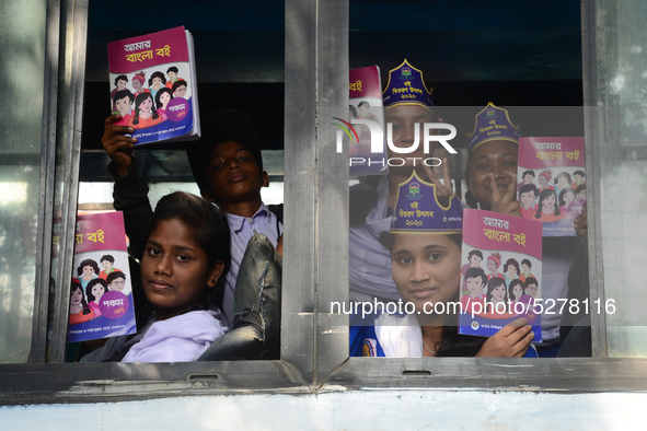 Student celebrate with new textbooks in hand at the Dhaka University sports ground the Dhaka University sports ground as the government kick...