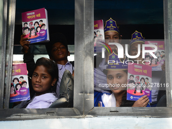 Student celebrate with new textbooks in hand at the Dhaka University sports ground the Dhaka University sports ground as the government kick...