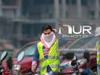 Indian and Sri Lankan construction workers walk out of a mega-construction site wearing  face masks following  the  Corona virus outbreak in...