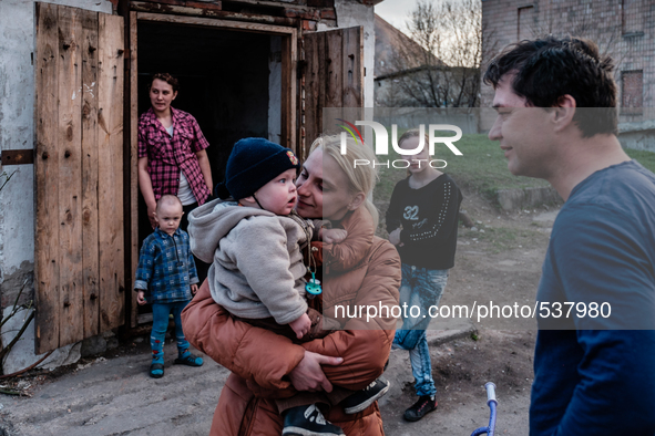 Tomas Vlach (on the right) emergency coordinator for the NGO "People in Need" welcome by some members of families living in the bunker.  Las...