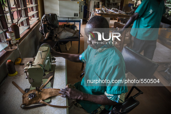 A worker sews in the Bombuaka workshop of prostheses, Togo 