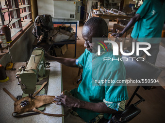 A worker sews in the Bombuaka workshop of prostheses, Togo (