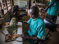 A worker sews in the Bombuaka workshop of prostheses, Togo (