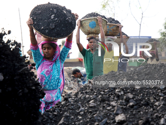 Bangladeshi laborers unload coal from boats  ahead of International Women's Day at the River Turag in Dhaka, Bangladesh, on March 7, 2020. (