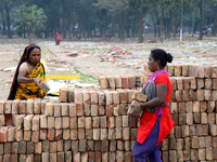 Bangladeshi woman daily labor works in a contraction site in Dhaka, Bangladesh, on March 7, 2020. Each woman labor earn 4.71 US dollar or 40...