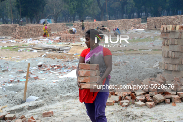 Bangladeshi woman daily labor works in a contraction site in Dhaka, Bangladesh, on March 7, 2020. Each woman labor earn 4.71 US dollar or 40...