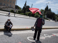 People wearing mask protest on International Worker's Day during the curfew due to Coronavirus (Covid-19) pandemic in Athens, Greece on May...