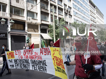 People wearing mask protest on International Worker's Day during the curfew due to Coronavirus (Covid-19) pandemic in Athens, Greece on May...