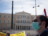 People wearing mask protest on International Worker's Day during the curfew due to Coronavirus (Covid-19) pandemic in Athens, Greece on May...